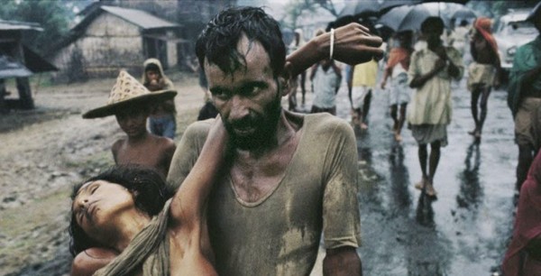A refugee carrying his cholera-stricken wife away from the fighting during the Bangladesh war, 1971