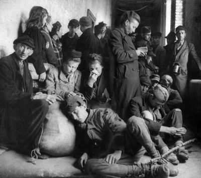 Exhausted, homeless German refugees hudd